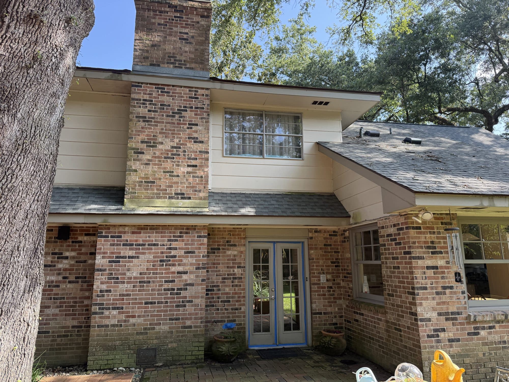 Rear elevation of a Gretna brick home with french doors after a wash