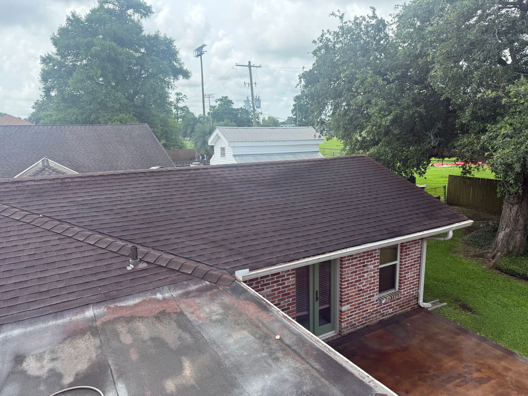 Shingle roof cleaned of algae under live oaks in Gretna